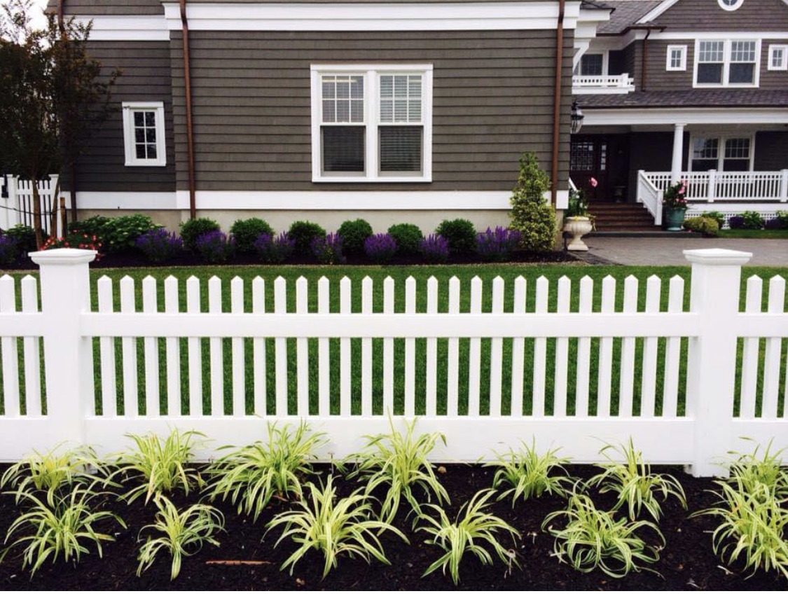 White picket fence in front of a home